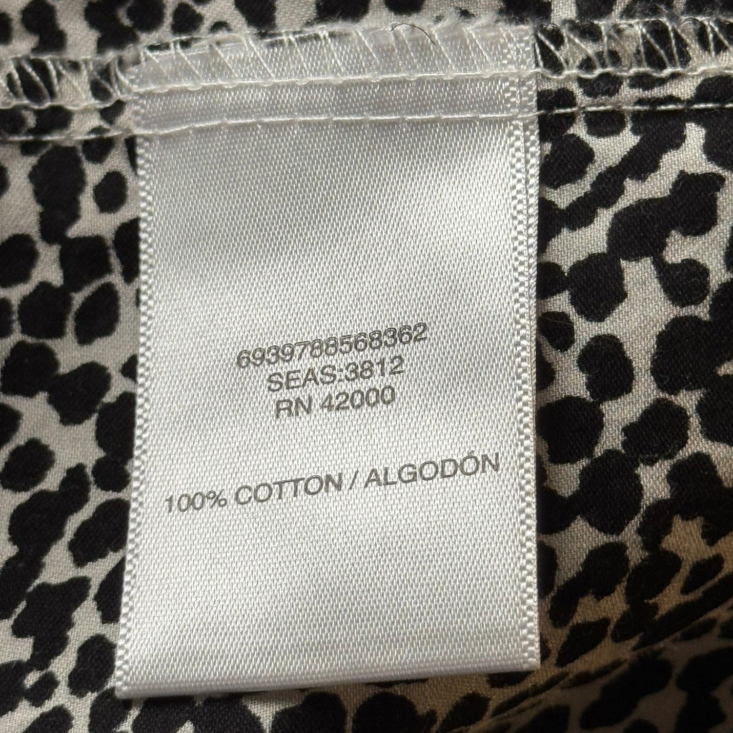 Product tag or label of Jaclyn Smith 100% black and white cotton animal print shirt in size L