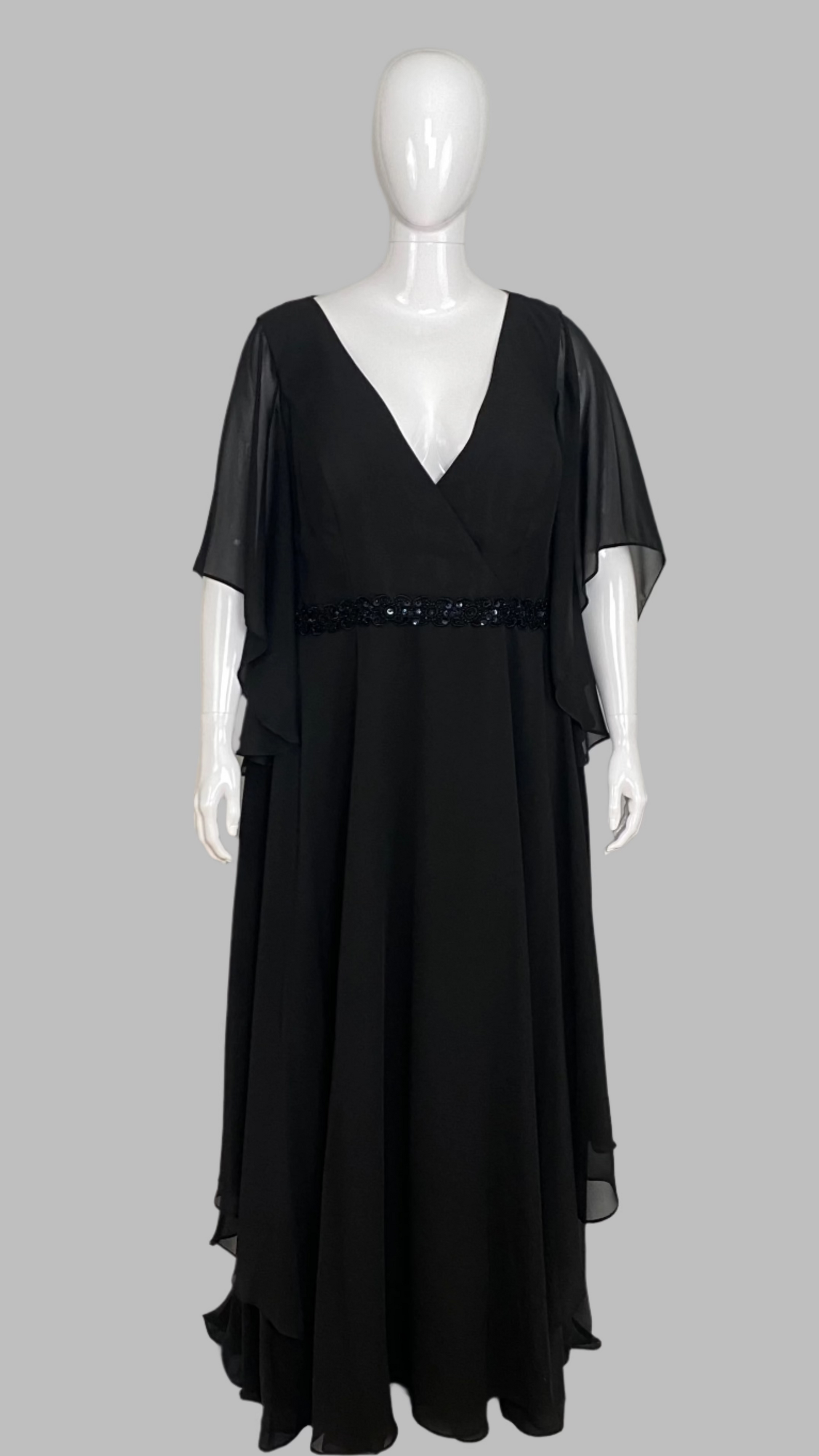 Black evening gown on a mannequin against a white background