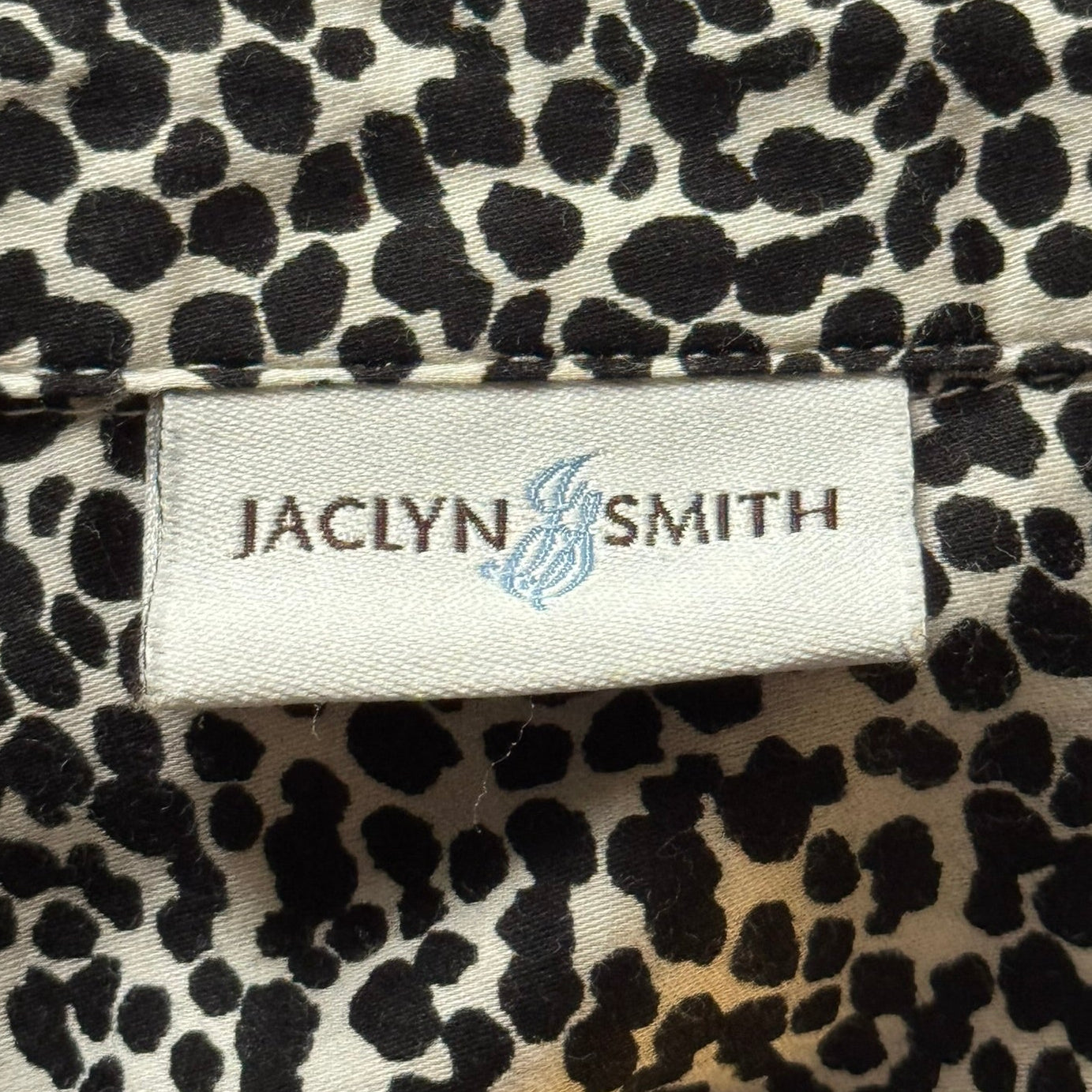 Product tag or label of Jaclyn Smith 100% black and white cotton animal print shirt in size L 